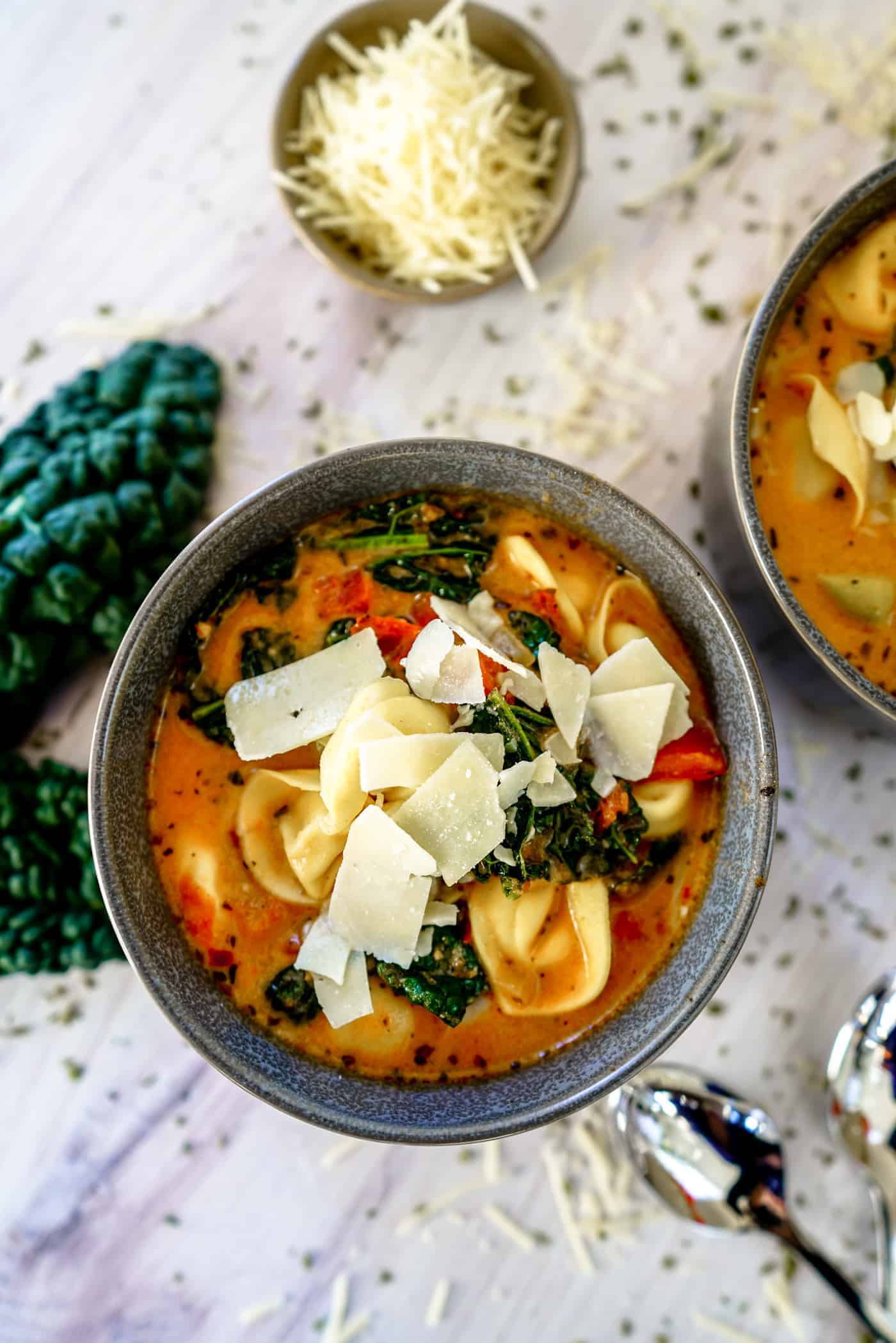 A Lily Love Affair shares a delicious Instant Pot Tortellini Soup recipe topped with parmesan cheese
