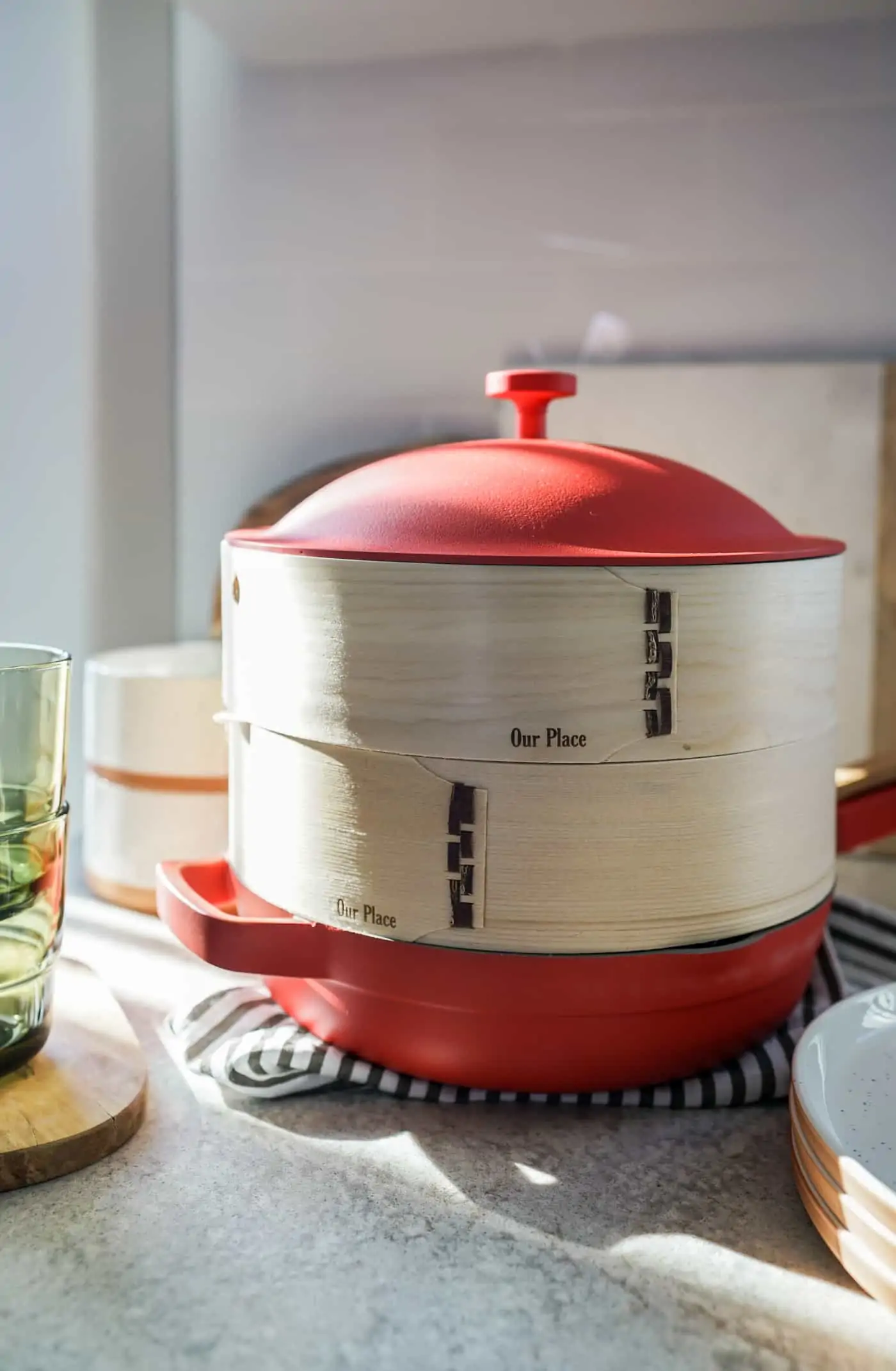 The Our Place Always Pan in color Heat with bamboo steamer inserts