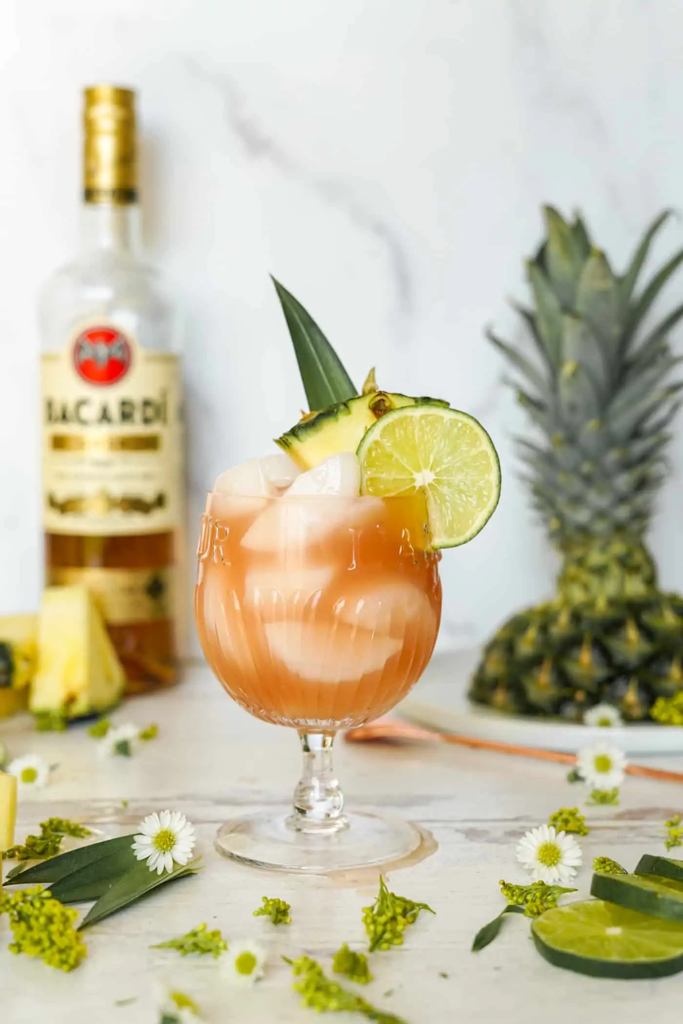 A glass filled with Bacardi rum punch topped with a lime wedge