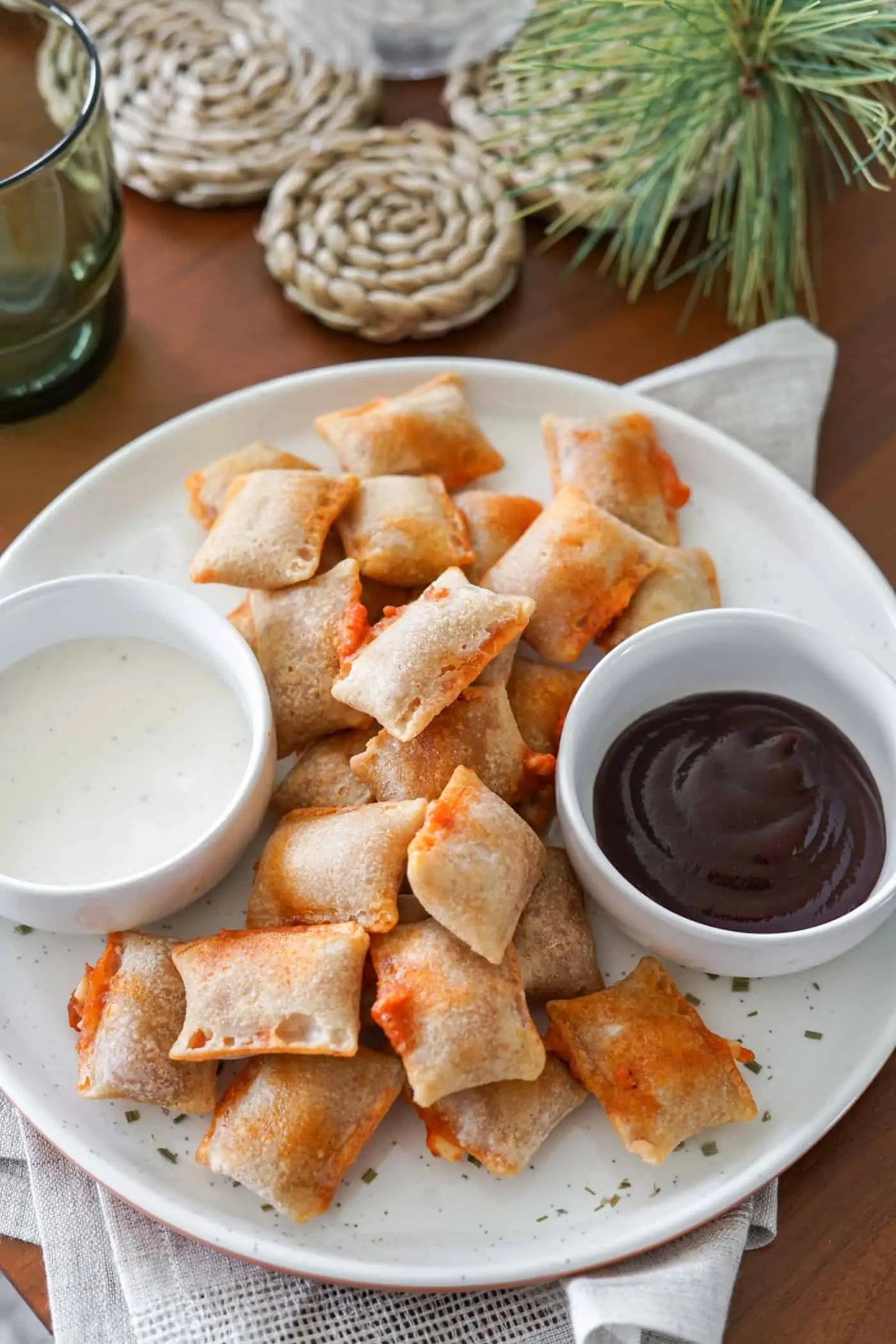 A plate of air fryer pizza rolls with ranch dipping sauce