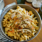 A large bowl of Instant Pot Chicken Fajita Pasta with bell peppers and onions.